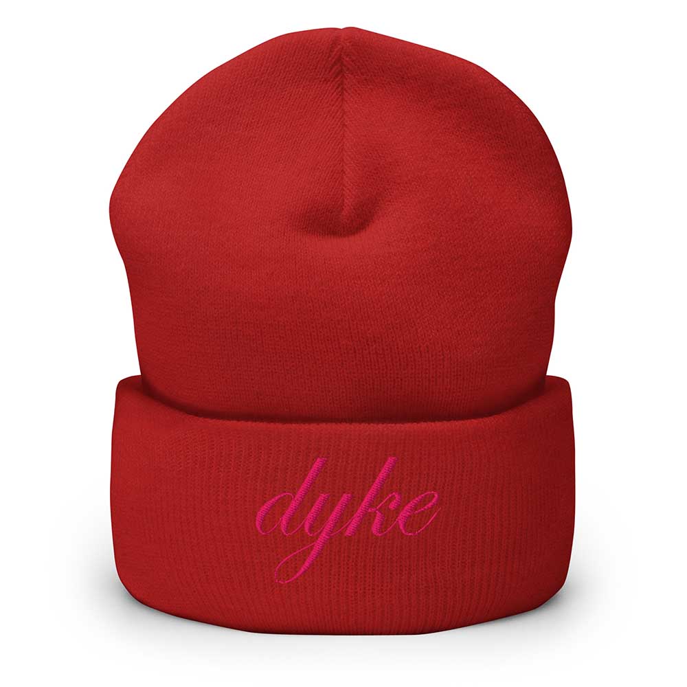 Red beanie with 'dyke' embroidered in pink on a white background