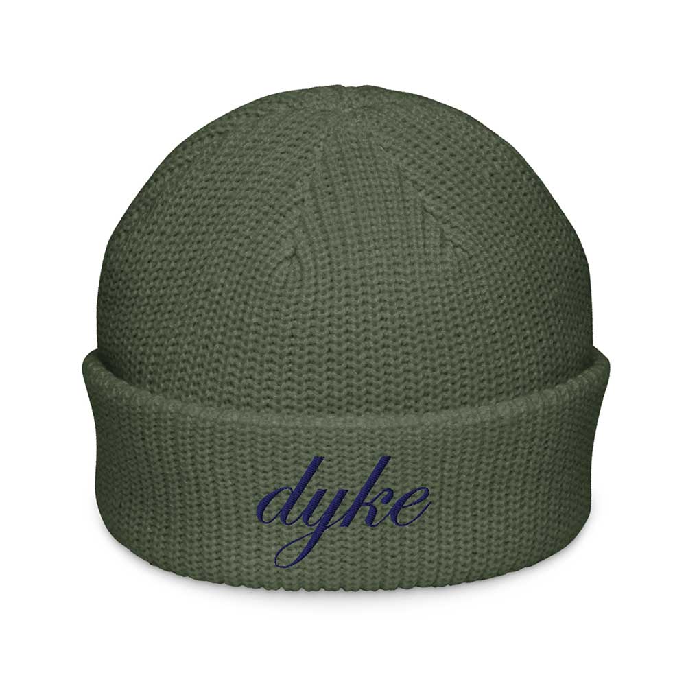 Green beanie with 'dyke' embroidered on a white background