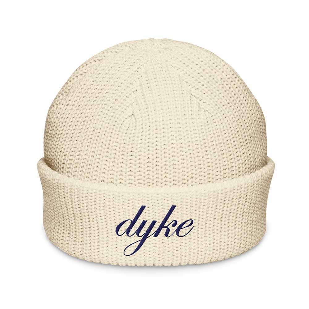 Beige beanie with 'dyke' embroidered on a white background