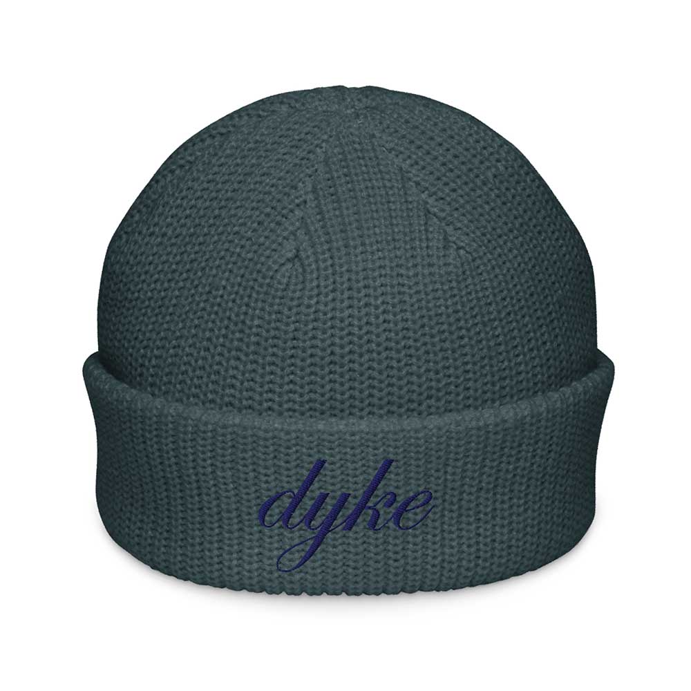 Dark teal beanie with 'dyke' embroidered on a white background