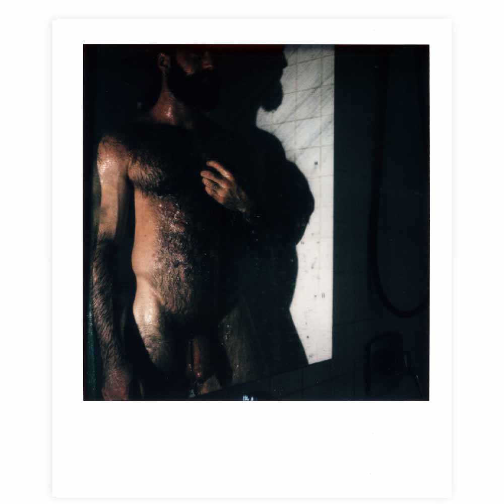 color polaroid photo of hairy nude man in shower