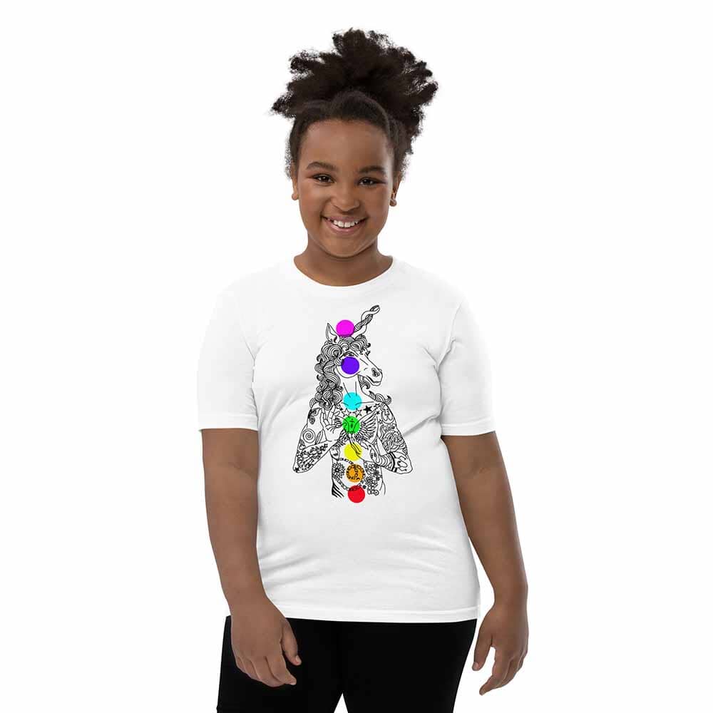 Child wearing a white t-shirt with a colorful unicorn design on a white background
