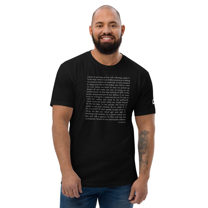 Male model wearing black fitted Leo Herrera Cheers to Growing Up Gay t-shirt, front view, Adam&