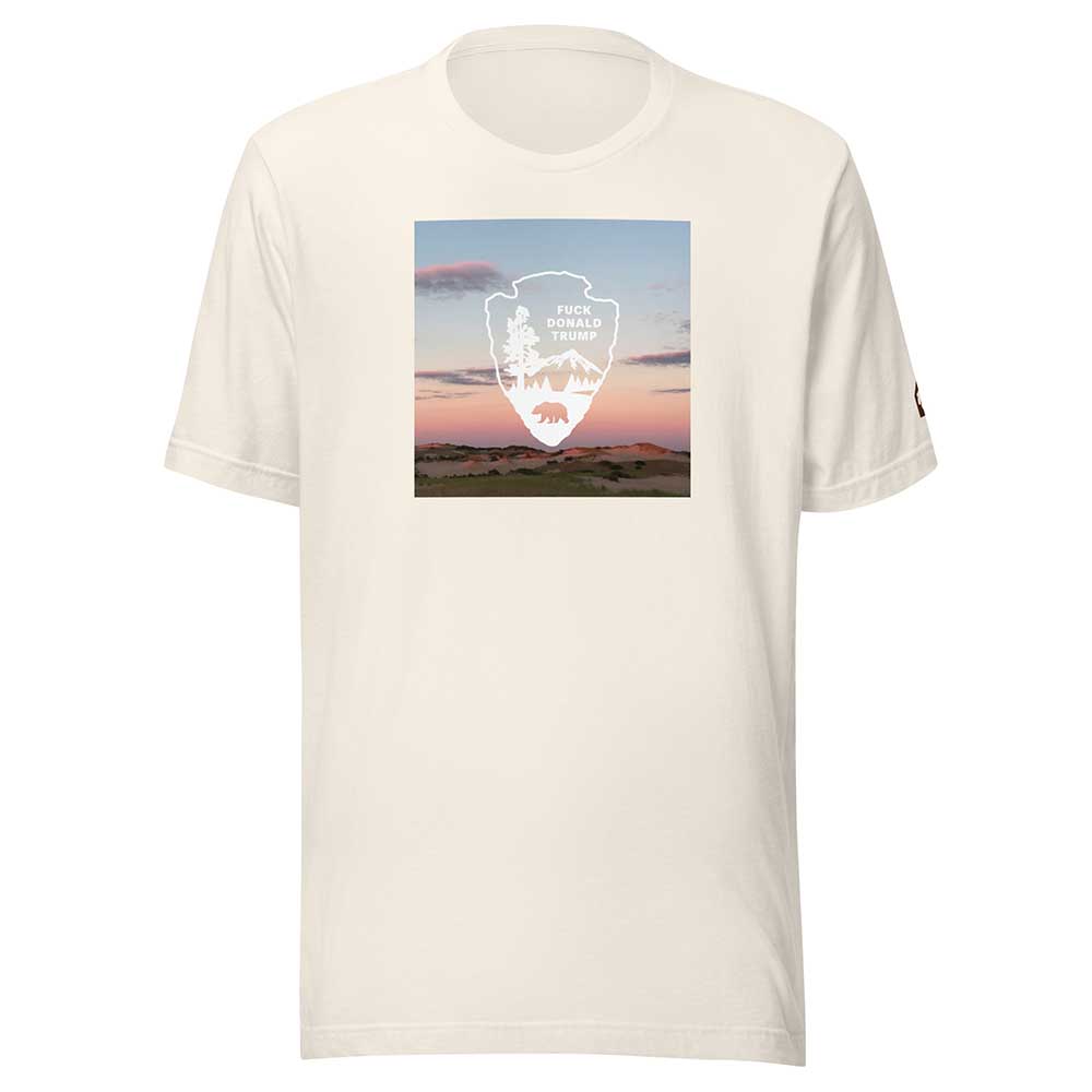 White t-shirt with a graphic design of a sunset over a field and a logo on a white background