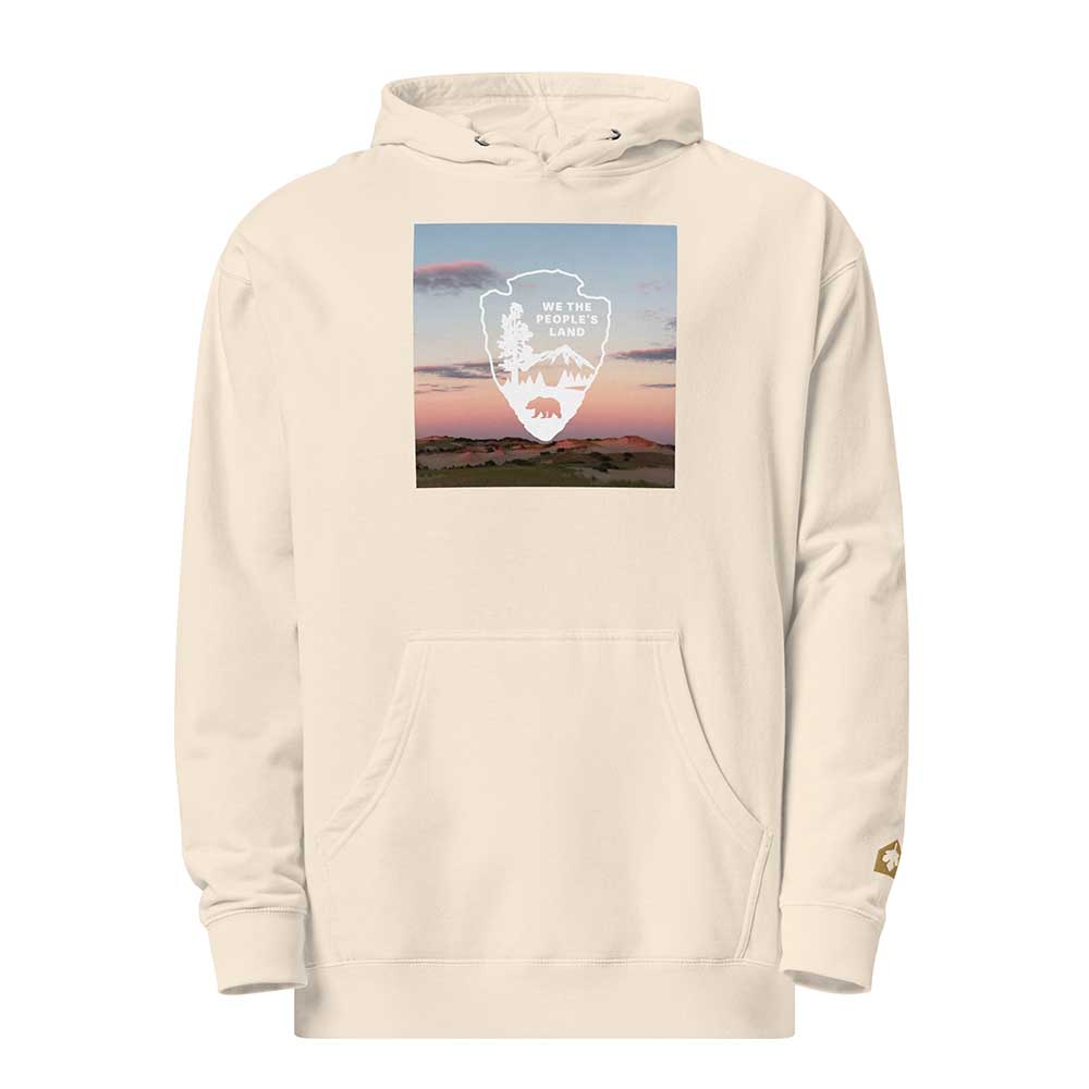 Beige hoodie with a graphic of a mountain and bear design on a white background