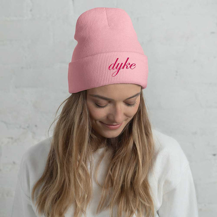 person wearing a pink beanie with &