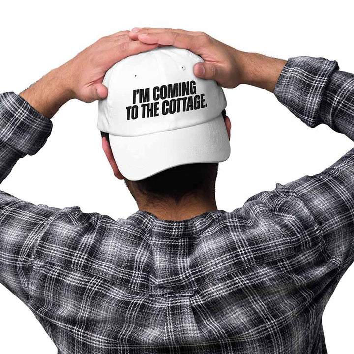 Person wearing a white cap with text &