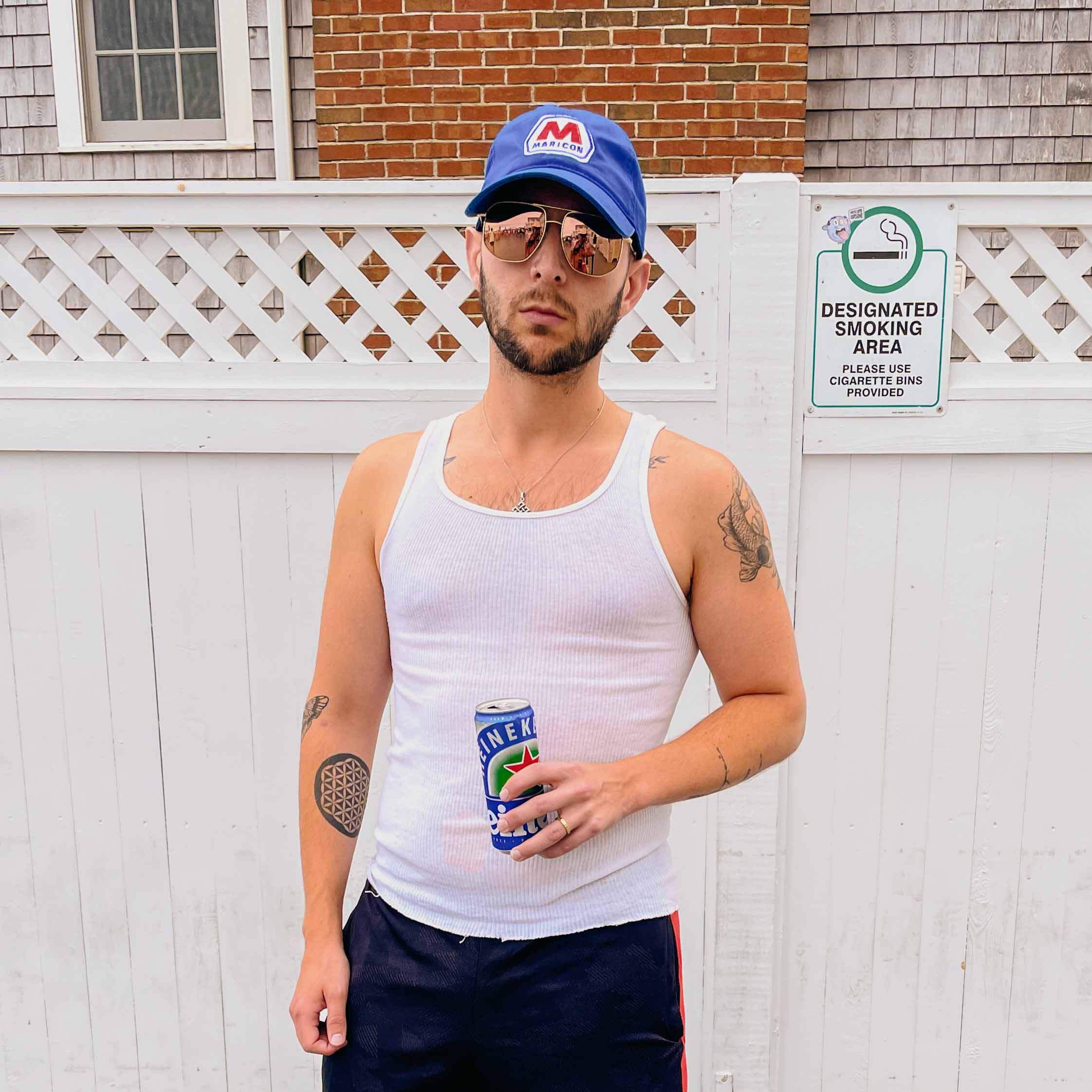 man in tank wearing maricon royal blue  twill dad hat