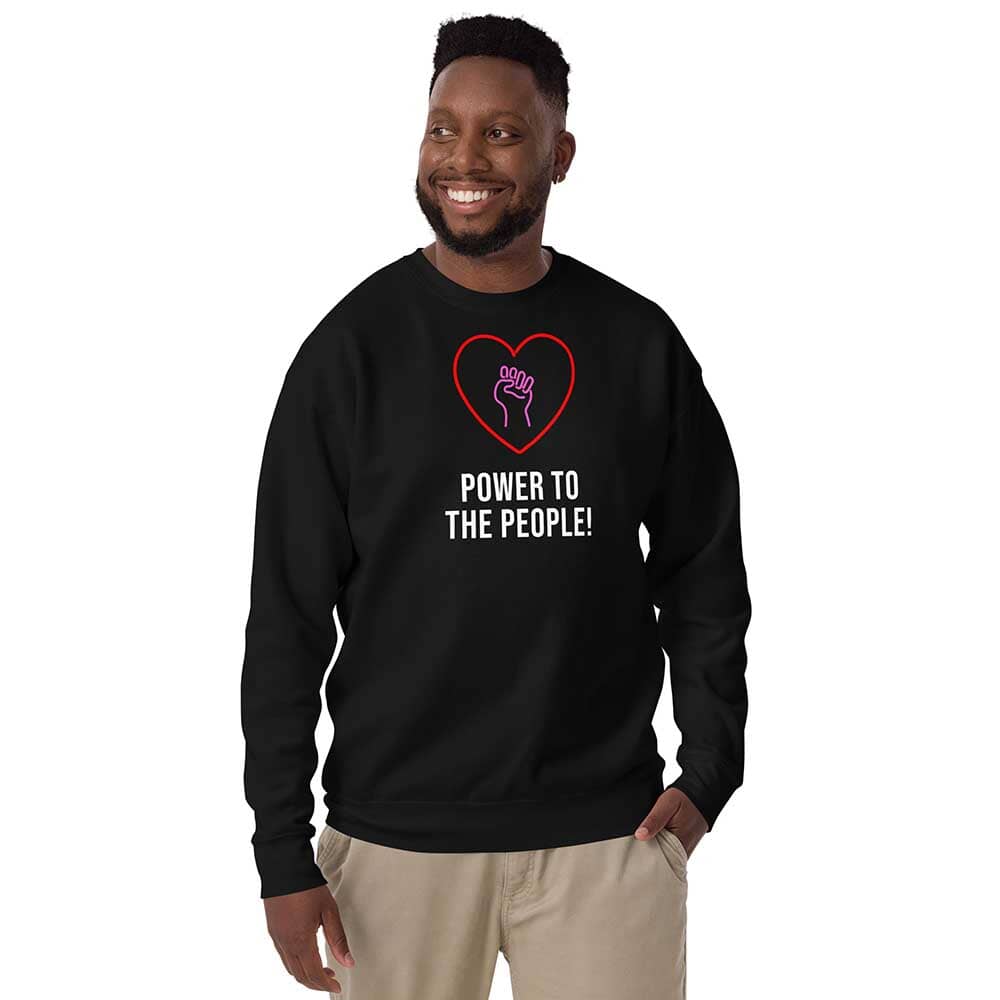 Person wearing a black sweatshirt with a heart and fist design, text 'Power to the People', on a white background