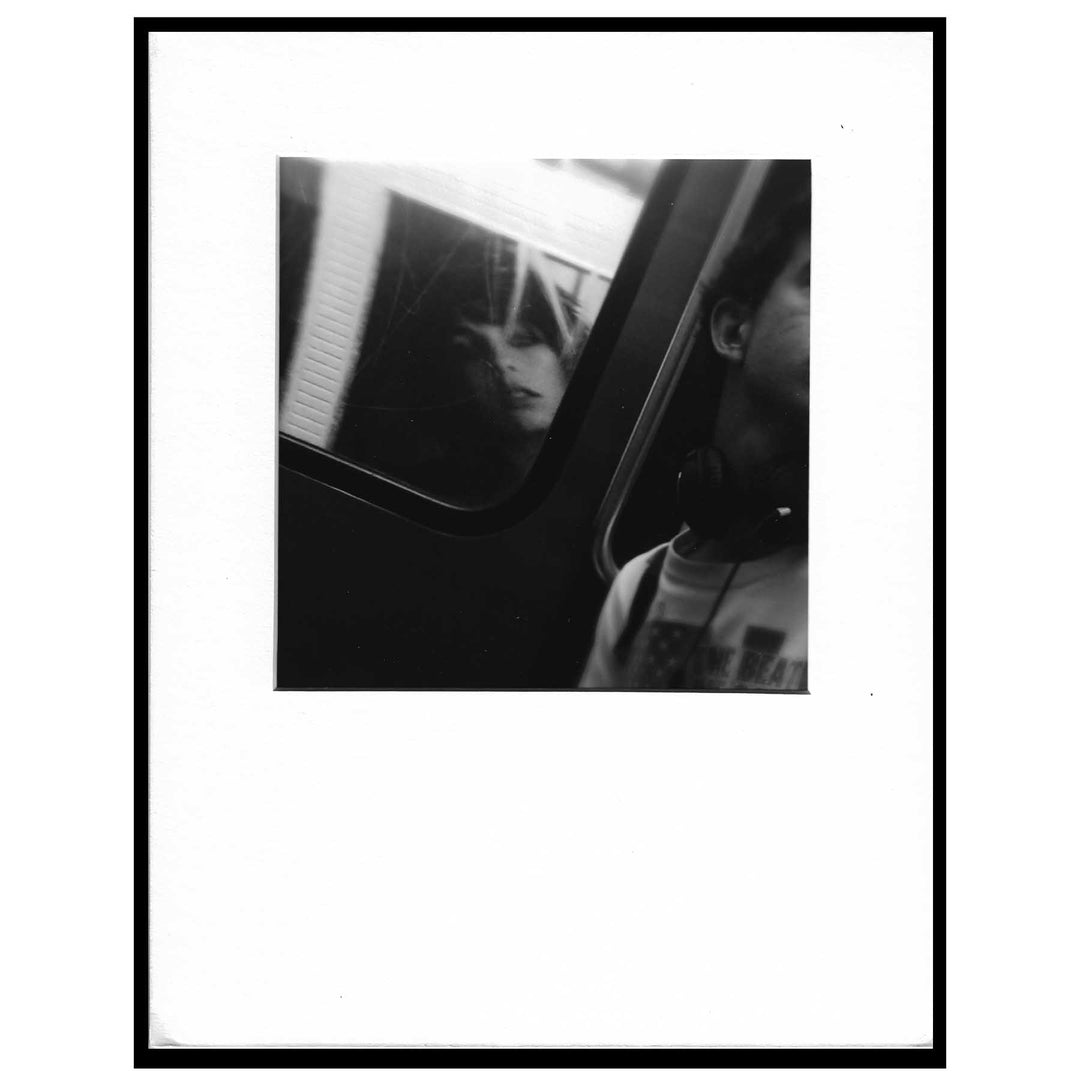 black and white photo of headphones around a guy's neck