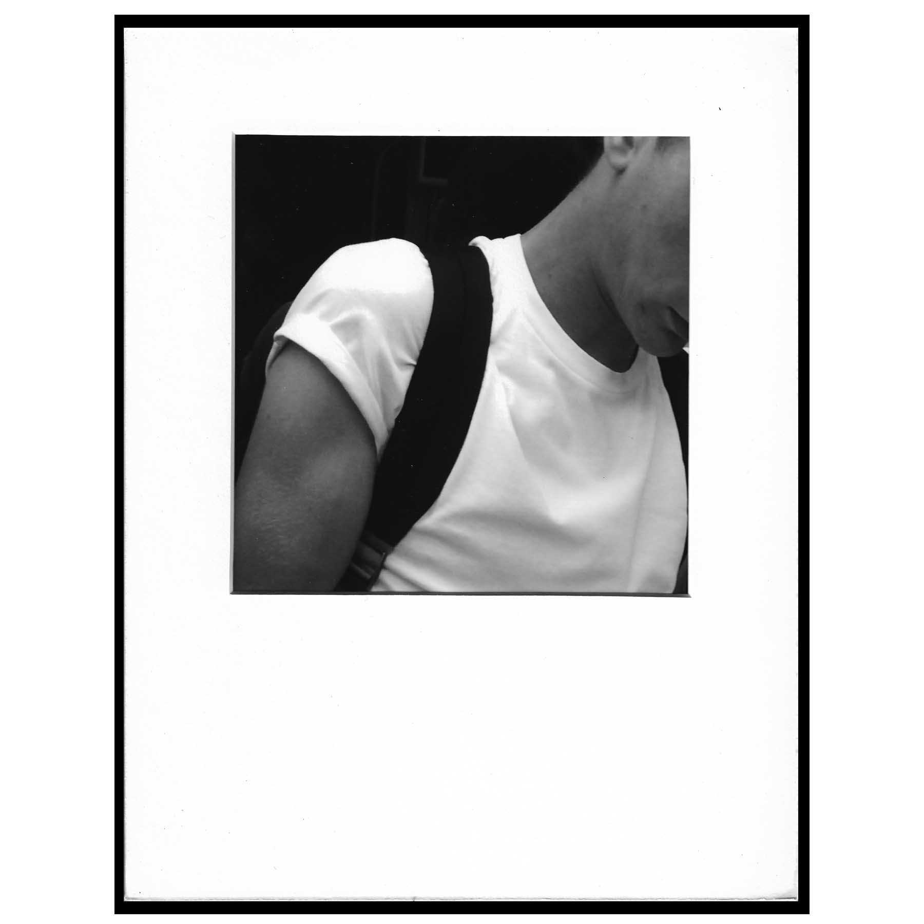 black and white photo of white t-shirt backpack strap