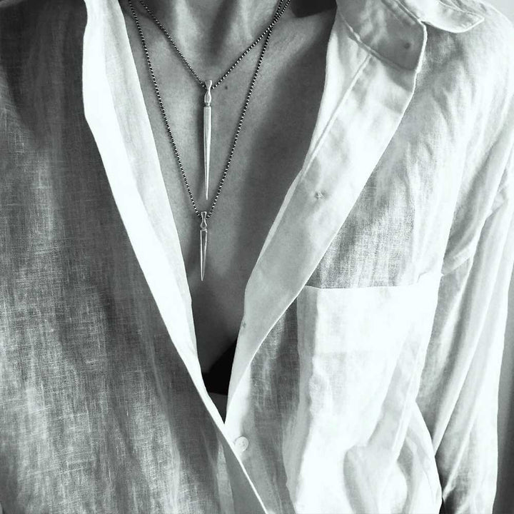 Gladius Sword Necklace in Silver on model in shirt layered